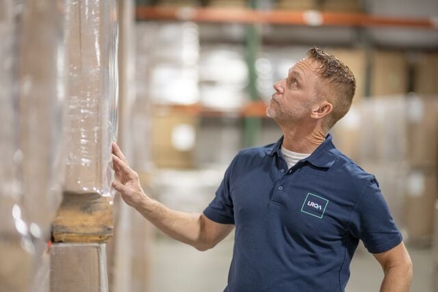 Lrqa worker looking at boxes